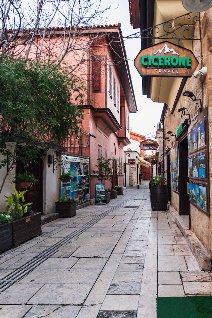 Picturesque alleyway in Antalya, Turkey showcasing travel agency signs and cozy architecture.